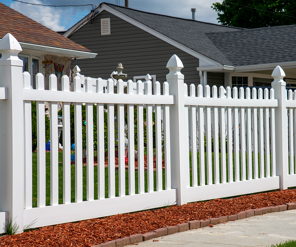 fence-contractor-sugarcreek-White-fence White vinyl fence in suburban yard installed by fence contractor Sugarcreek