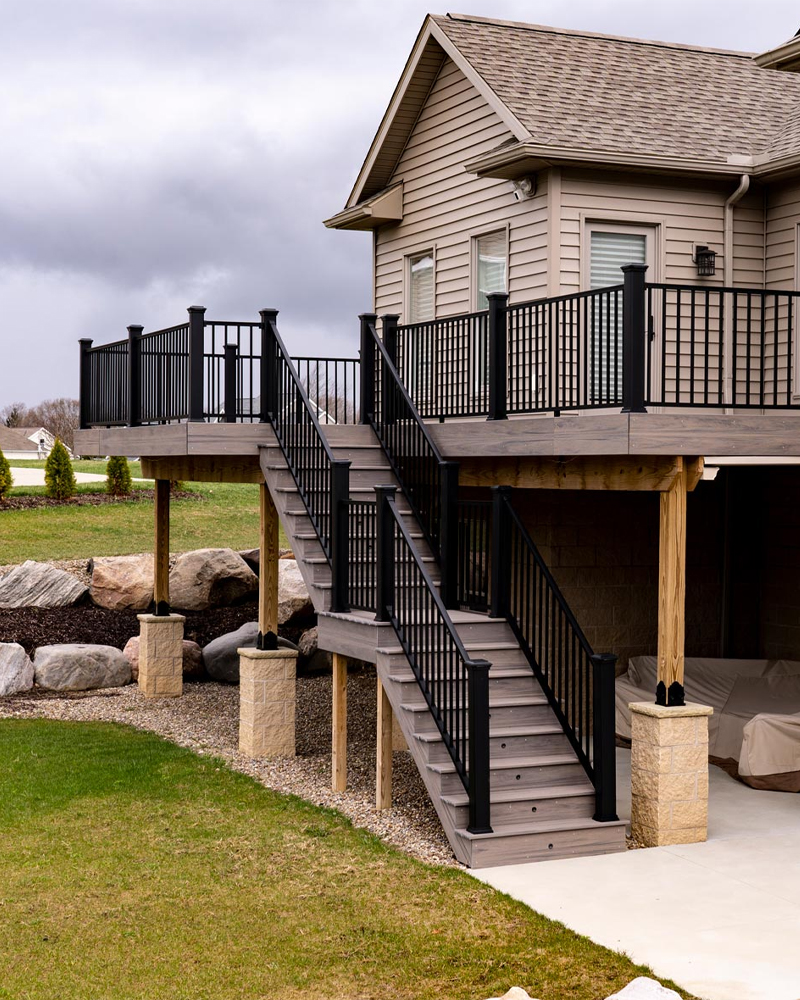 Two-story composite deck by custom deck builder in Dundee, OH.