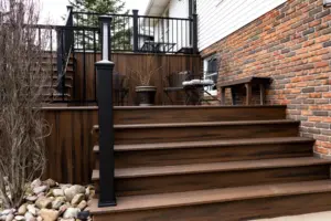 Composite backyard deck with wide stairs, showcasing professional deck repair and deck replacement services.